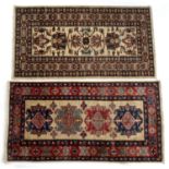 Two contemporary rugs each with central ivory ground panels with foliate and stylised designs, 132cm