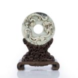 Jade archaic style disc Chinese, Eastern Zhou style the disc carved with chi-lin dragons, on a