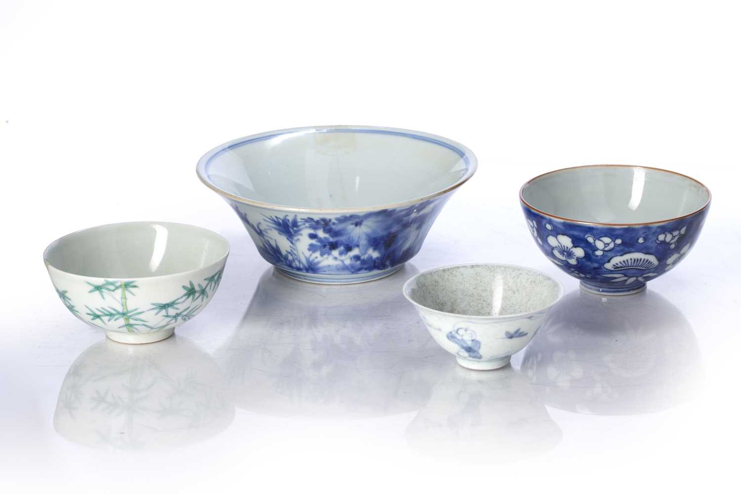 Group of four bowls Chinese to include a foliate decorated bowl with three lines of inscription,