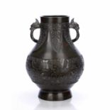 Bronze 'Hu form' vase Chinese with shaped animal head handles, the body decorated with a band of