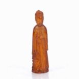 Red amber figure of Lan Ts'ai Chinese, 19th Century in long robes representing one of the Pa Sien or