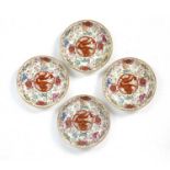 Four famille rose saucer dishes Chinese decorated with a five-clawed dragon surrounded by Buddhist