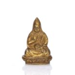 Gilt bronze figure of the 5th Dalai Lama Tibetan with one hand resting on the lap holding an object,