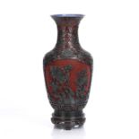 Red and black lacquer vase Chinese, 20th Century carved with foliate motifs, with an inner metal