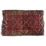 Red ground rug Afghanistan with three central medallions, 121cm x 77cmCondition report: Worn with