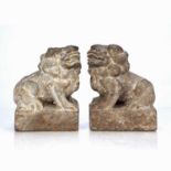 Pair of mottled stone model Buddhist lions Chinese, 18th/19th Century each set upon a rectangular