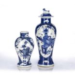 Two blue and white prunus vases Chinese, 19th Century one lidded, both decorated with antiques and