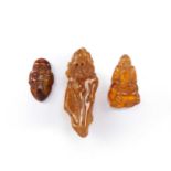 Amber carving of Shou Lao Chinese 5cm high, a tiger's eye carving 4cm and an amber pendant 8cm