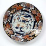 Arita polychrome plate Japanese, Edo period with central fan design, within a border of flowers,