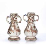 Pair of Satsuma vases Japanese decorated with deer, with looped floral handles, 28cm high (2)