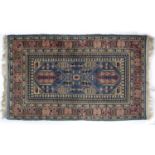 Blue ground rug Pakistan with panelled pink ground border, having stylised designs, 160cm x