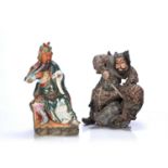 Two guardian figures Japanese comprising of a ceramic figure holding a book to the hand while