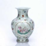 Famille rose vase Chinese enamelled with three panels of figures within a surround of flower sprays,