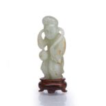 Jade carved figure Chinese carved carrying an object suspended by a rope, with a fitted stand, 7.5cm