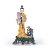Famille rose figure of Magu Chinese, 19th Century holding a large vessel to one hand, dressed in
