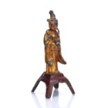 Gilt metal standing Buddha Chinese, 17th/18th Century on a red painted base, 18.5cm highCondition