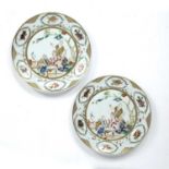 Pair of famille rose plates Chinese painted in enamels with scholars and other figures, within