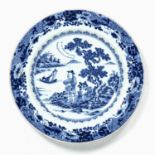 Blue and white plate Chinese, 18th century decorated with a figure next to a river landscape, 23.5cm