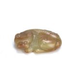 Tang style greyish green and russet marked jade pebble Chinese, late Ming carved as mythical lion-