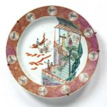 Famille rose charger Chinese, 18th Century depicting a castle on a rocky outcrop with figures