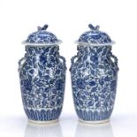Pair of blue and white lidded vases Chinese, 19th Century decorated with lotus and floral blossom,