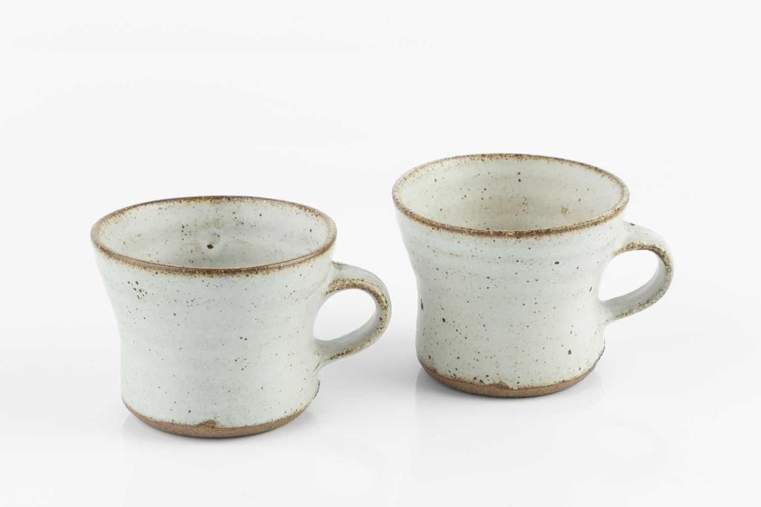 Gwyn Hanssen Pigott (1935-2013) Two coffee cups oatmeal glaze both with impressed potter's seal 6.