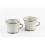 Gwyn Hanssen Pigott (1935-2013) Two coffee cups oatmeal glaze both with impressed potter's seal 6.