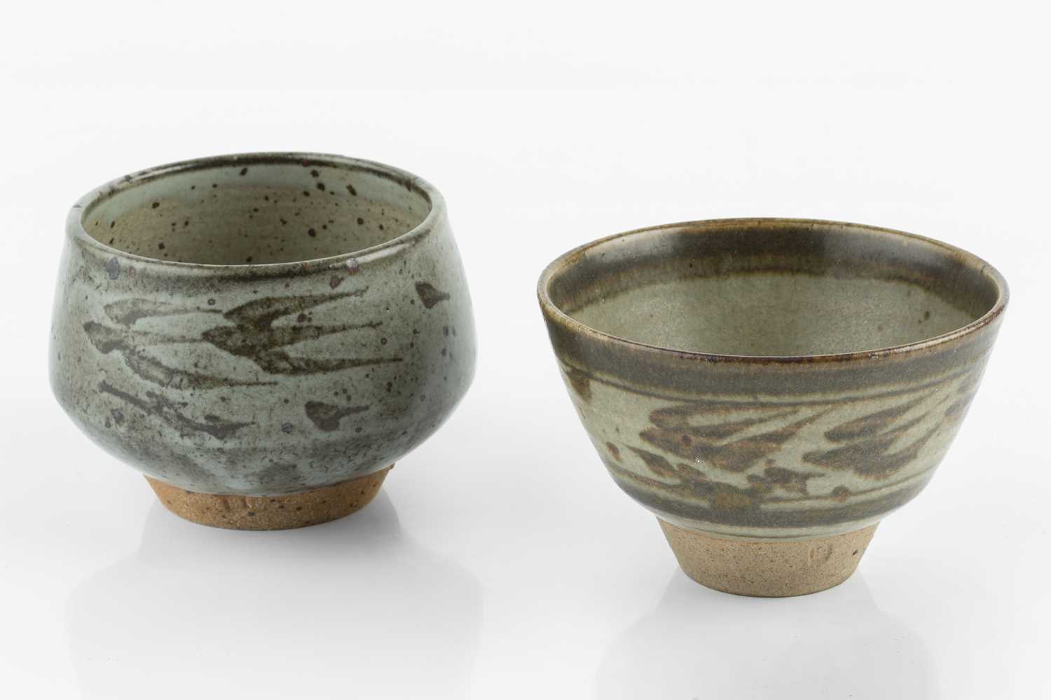 Helen Pincombe (1908-2004) Two tea bowls decorated with birds over grey glazes both with impressed