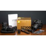 A Nikon D7100 Camera Outfit to include MB-D15 battery pack and charger, a VR AF-S Nikkor 18-200mm