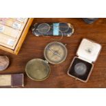 A group of collectable items to include two compasses, Coal mine tokens, opera glasses, Bently watch