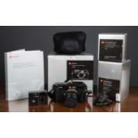 A Leica M9 Digital Rangefinder Camera in black, serial number 3810895 with its original box and