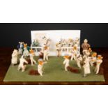 A diorama of a cricket match between foxes and badger including cricket pitch and pavilion with