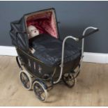 A Vintage doll's metal pram with a WPS folding plastic hood, the sides decorated with parrots on one