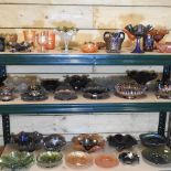 Three shelves of carnival and coloured glass,