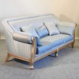 A gilt framed and pale blue upholstered sofa