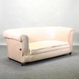 An early 20th century cream upholstered chesterfield sofa,