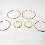 A collection of 9 carat gold hoop earrings,