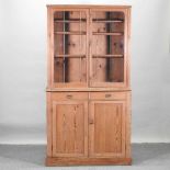 An antique pine glazed cabinet,