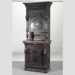 A late 19th century carved oak cabinet,