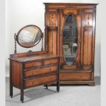 A 1920's oak Jacobean style single wardrobe,