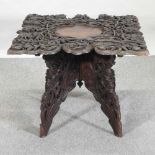 An early 20th century Indian carved occasional table,
