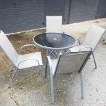 A glass top circular garden table,