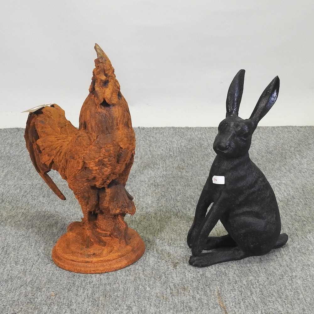A rusted metal model of a cockerel, together with a model of a hare