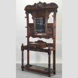 A 19th century heavily carved dark oak hallstand,