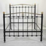 A Victorian style black painted iron and brass bedstead,
