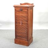 An early 20th century oak tambour front filing cabinet,