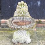 A reconstituted stone bird bath,