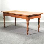 A 20th century light oak dining table,