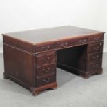 A reproduction pedestal desk,