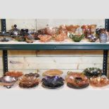 Two shelves of carnival and coloured glass,